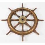 A ship's oak and brass eight spoke wheel,