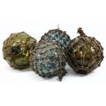 Four large glass floats:, of typical form with ropework..