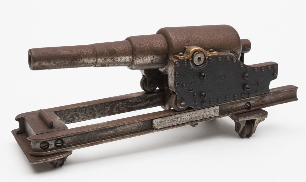 A steel and brass model of a coastal battery cannon:,