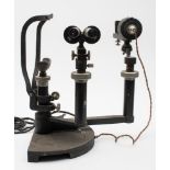 An optometrist's slit lamp by Hamblin, London:, with black crackle finish. .