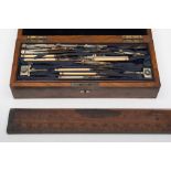 A late 19th/early 20th century walnut cased geometry set, together with a brass mounted rule:,