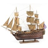 A wood block model of HMS Victory: partially rigged with lifeboats and  brass cannon,