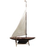 A late 19th/ early 20th century pond yacht:, fully rigged over deck fittings,