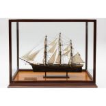 A scratch built model of the Cutty Sark: contained in a mahogany and glass panel case,