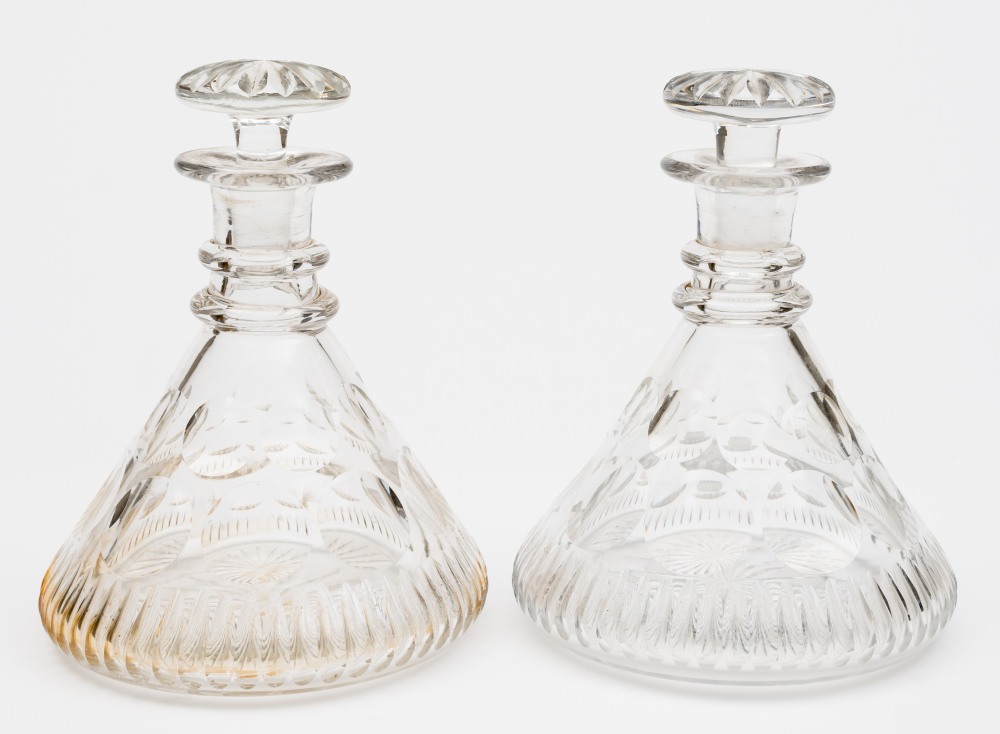 A pair of cut glass ship's decanters:, of typical form with mushroom stoppers ,