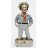 A Staffordshire pottery figure of Jolly Jack Tar: painted in colours on an oval base, 30cm high.