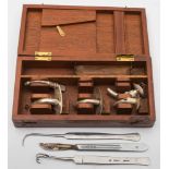 A mahogany cased tracheotomy kit:, in a fitted case (incomplete).