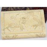 An early 20th century carved ivory cigarette case: of rectangular outline,