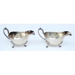 A pair of Edward VII silver sauce boats, maker GH, Sheffield, 1903: with wavy edge borders,