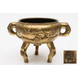 A Chinese bronze tripod censer: with all-over prunus decoration,