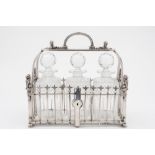 A late Victorian plated three bottle tantalus: the cage of garden fence design,