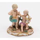 A Meissen porcelain allegorical group of two cherubs emblematic of Geography: one holding a globe,