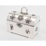 A white metal domed jewellery casket: the domed hinged lid with spiral loop handle,