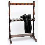 An early 20th century mahogany boot stand together with a pair of black leather riding boots:.