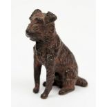 A cold painted bronze of a seated Terrier:, 4.5cm high.