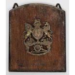 A Royal Artillery brass military helmet plate: mounted on a polished board.