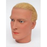 An early 20th century male wax mannequin head:,  with real hair, glass eyes and painted face,