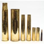 Seven brass shell cases: various calibres and dates.
