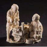A Japanese carved ivory okimono of street flower sellers, Meiji period:,