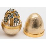 A Stuart Devlin silver-gilt egg, London, 1979: the interior with enamelled floral spray, 7.5cm.