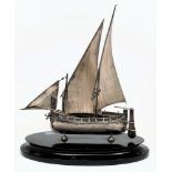 A Dutch silver model of a two-masted sailing boat: with sails, oars and tiller,