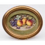 A porcelain plaque in the Royal Worcester manner: of oval form painted by Bryan Cox with apples,