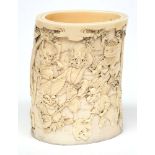 A Japanese carved ivory brush pot:, Meiji period, signed, the sides decorated with dancing oni's,