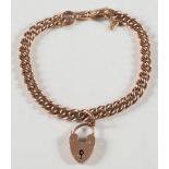 A 9ct gold curb-link bracelet: with padlock clasp and safety chain,