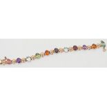 A multi-gem set bracelet stamped '18K' with eleven various coloured,