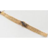 An 18ct gold and sapphire mounted mesh-link bracelet: with loose clasp fitting.