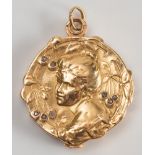 An early 20th century French gold locket with diamond chips:.