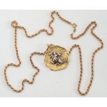A circular pendant/brooch of textured design depicting female Arabian water carrier:,