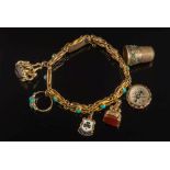 A 9ct gold and turquoise mounted bracelet: with six various attached gold charms including a
