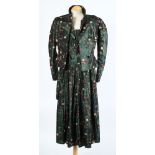 A green silk and floral two-piece skirt suit together with a green velvet dress,