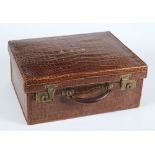 A crocodile skin suitcase:,  initialled A.E.W, 47 x 36cm.