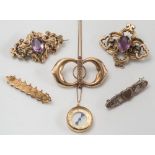 Four gold and gold plated brooches, a silver sweetheart brooch and a compass pendant on chain:.
