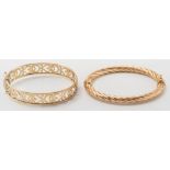A 9ct gold hinged bangle of pierced design and a gold rope-twist design bangle:.