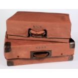 Two brown brushed suede suitcases:, each with canvas cover, largest 64 x 44cm.