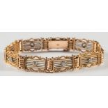 A 15ct gold and diamond set gate-link bracelet:, each panel set with a circular,
