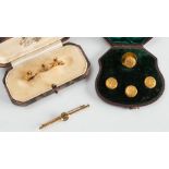 A cased set of foliate engraved dress studs, three gold dress studs and a three stone bar brooch:.