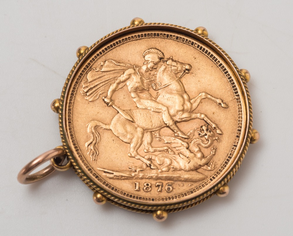 A gold sovereign dated '1876', within a pendant frame:.