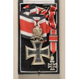 Knights Cross of the Iron Cross, with Oak Leaves and Swords, 1957, in case. Blackened core, oak