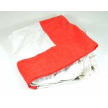 Red-Cross-flag. White fabric with printed red cross, with fittings on the corners. 110 x 110 cm.