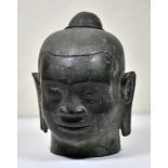 Bronce head of the meditating Buddha. Bronce, heavily patinated surface, fine details of the head