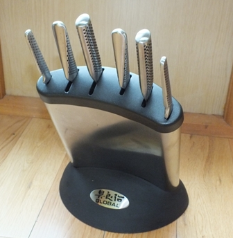 A Global knife block containing six stainless steel knives, and a good collection of kitchen