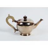 A silver bullet shaped teapot, Mappin & Webb, London 1935, of plain polished form with turned wood