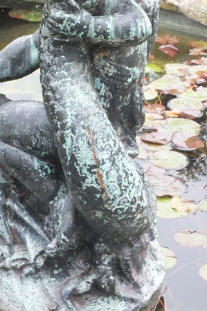 A 20th century bronze fountain figure in the form of a winged cherub riding on the back of an exotic - Image 4 of 4