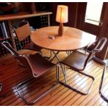 A maple veneer topped circular folding dining table, 1.06m diameter, together with a "Cadman" inlaid