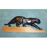 A late 20th century bronze effect resin model of a panther, mounted on wooden block, 28cm high