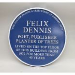 A blue plaque inscribed "Felix Dennis poet, publisher, planter of trees - lived on the top floor